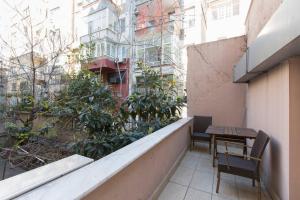 a balcony with a table and chairs on a building at Derpa Suite Hotel in Istanbul