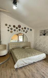 a bedroom with a bed and a mirror on the wall at Arkada Hotel Kharkiv in Kharkiv