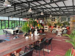 a large patio with a wooden table and chairs at Blue Indigo yoga Cambodia in Phnom Penh