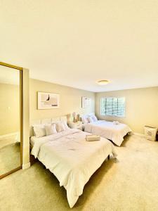 a large bedroom with two beds and a mirror at Stunning apartment steps from Ocean Beach in San Francisco