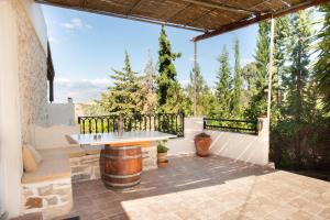 a patio with a table and a view of the mountains at Eirini's Traditional House in Lístaros