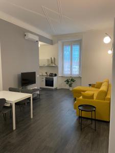 - un salon avec un canapé jaune et une table dans l'établissement CENTRALE APARTMENT, à Milan
