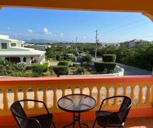 two chairs and a table on a balcony with a view at Tropix Getaway - rental car available in Crocus Hill