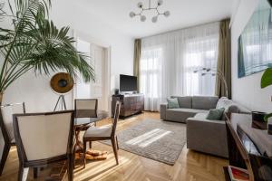 a living room with a couch and a table at Aviator luxury apartment in the city center in Budapest