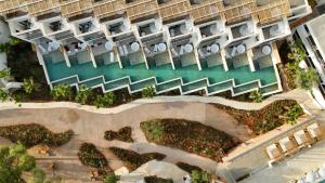 an aerial view of a resort with a pool at The Signature Level at TRS Ibiza Hotel - All Inclusive Adults Only - Entrance to Clubs included in San Antonio +37 photos