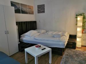 a small bedroom with a bed and a table at Trier City Center Apartments Altstadt in Trier