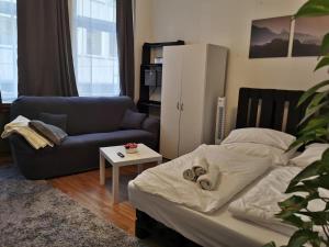 a living room with a bed and a couch at Trier City Center Apartments Altstadt in Trier