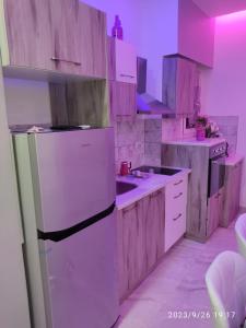 uma cozinha com um frigorífico branco e armários de madeira em OpenSpace 50 mq con Giardino em Sharm el Sheikh