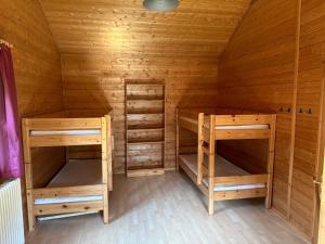 a wooden cabin with two bunk beds in it at ZeitFürMich in Losheim