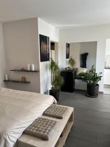 a bedroom with a bed and potted plants at Lorraine in Bern