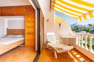 a bedroom with a bed and a balcony at Club Atlantis Aparthotel Ocean View in Adeje