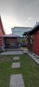 a backyard with a swimming pool between two buildings at Lille huset in Holmestrand