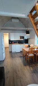 a kitchen and dining room with a table and chairs at Lille huset in Holmestrand