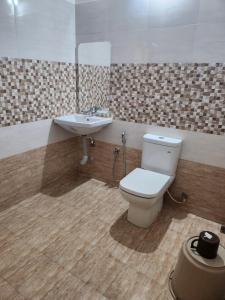 a bathroom with a toilet and a sink at vintage valley urban cottage in Thodupuzha