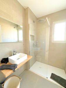 a white bathroom with a sink and a shower at Duplex Marina Rossa in Lecci
