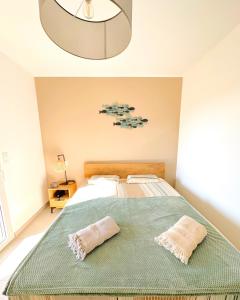 a bedroom with a bed with two pillows on it at Duplex Marina Rossa in Lecci