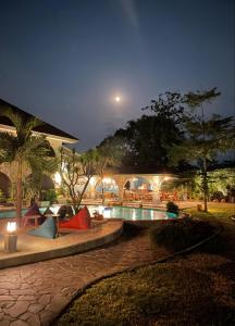 a resort with a swimming pool at night at La Collina Villa in Jepara