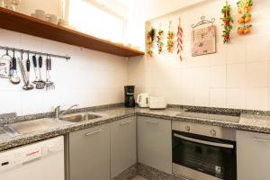 a kitchen with a sink and a counter top at Club Atlantis Aparthotel Ocean View in Adeje