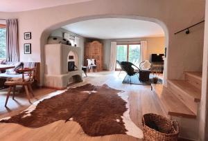 a living room with an archway and a living room with a fireplace at KitzMoments by Belle Stay in Reith bei Kitzbühel