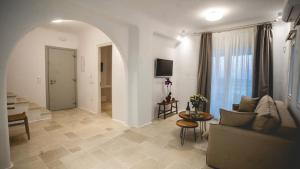 a living room with a couch and a table at Gaia Mykonos Villas & Suites in Tagou