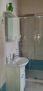 a bathroom with a sink and a shower at Il Centrale Guest House in Nuoro
