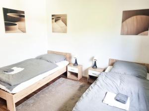 a bedroom with two beds and two night stands at cozy Apartment with Balcony in Kronberg im Taunus