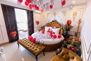 a room with a table and a bed with balloons at Royal Hotel Sài Đồng - Long Biên in Hanoi