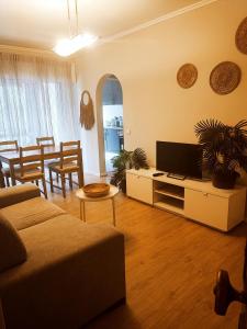 a living room with a couch and a table at O. Li Apart Estoril in Estoril