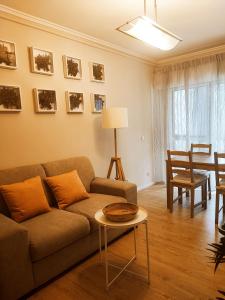 a living room with a couch and a table at O. Li Apart Estoril in Estoril