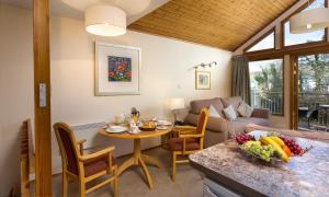 a living room with a table and a couch at Keswick Bridge Lodge Resort in Keswick
