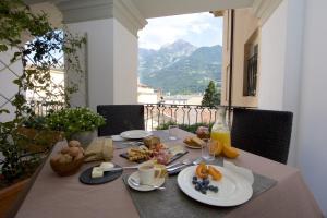 a table with plates of food on it with a view at Ma Ville in Aosta