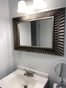 a bathroom with a sink and a mirror at Charming City Bungalow in Jacksonville