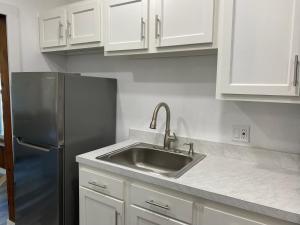 a kitchen with a sink and a refrigerator at Charming City Bungalow in Jacksonville