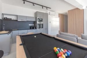 a kitchen with a pool table in a living room at Seaview And Wellness Penthouse In Gozo - Happy Rentals in Xagħra