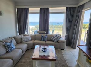 a living room with a couch and a table at Casa Uvongo 110 in Uvongo Beach