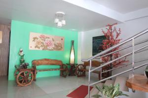 a living room with a staircase and green walls at COCOS HOTEL in Compostela