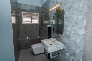 a bathroom with a sink and a toilet at HOTEL BLUEMOON in Tirunelveli