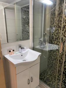 a bathroom with a sink and a shower at Athens Central Apartment in Athens