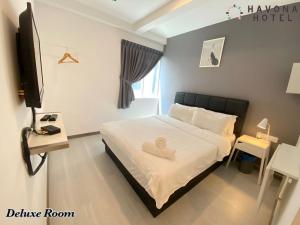 a bedroom with a bed with a heart on it at Havona Hotel - Kulai in Kulai