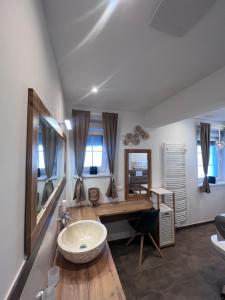 a bathroom with a sink and a desk and a mirror at Ferienhaus Purgar in Kammern im Liesingtal