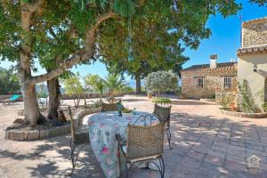 an outdoor table with chairs and a tablecloth on it at Villa Katerina in Benissa