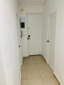 a hallway with two doors and a tile floor at Santa Bárbara in Alicante