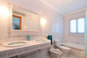 a bathroom with a sink and a toilet and a mirror at Villa Katerina in Benissa +32 photos
