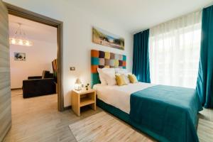 a bedroom with a large bed and a window at Alezzi Luxury Apartments & Spa Center in Mamaia Sat/Năvodari