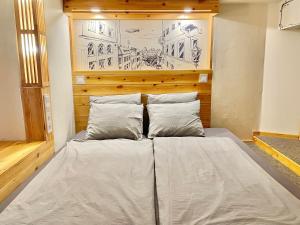 a bed in a room with a drawing on the wall at Lavender Circus Hand Drawn Apartments in Budapest
