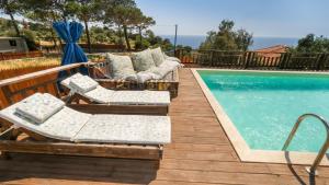 a deck with chairs and a swimming pool at Likya House - Deniz ve Doğa Manzaralı, Havuzlu in Patara