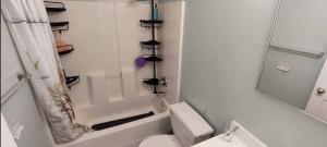 a white bathroom with a toilet and a shower at Central and Affordable house in Williamsburg Close to Subway in Brooklyn