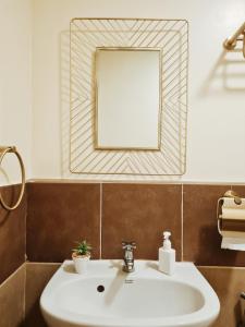 a bathroom with a white sink and a mirror at Cozy 1BR Condo near Airport Davao City in Davao City
