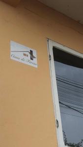 a sign on the side of a building next to a garage at Casa de Ferias in São Tomé
