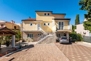 a house with a car parked in front of it at Apartments & Room Anita in Rovinj